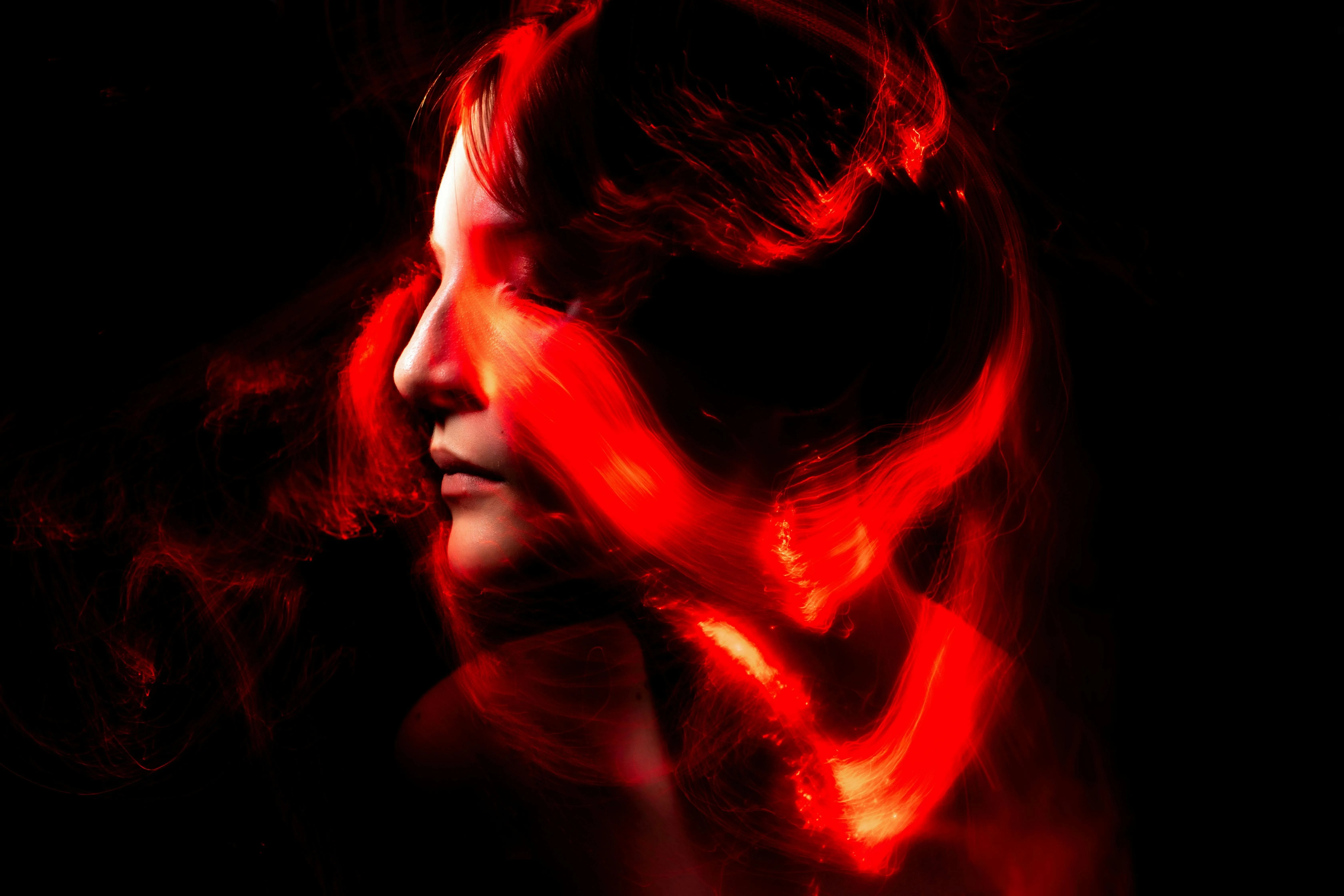 a woman with red light around her head for are neon lights plasma