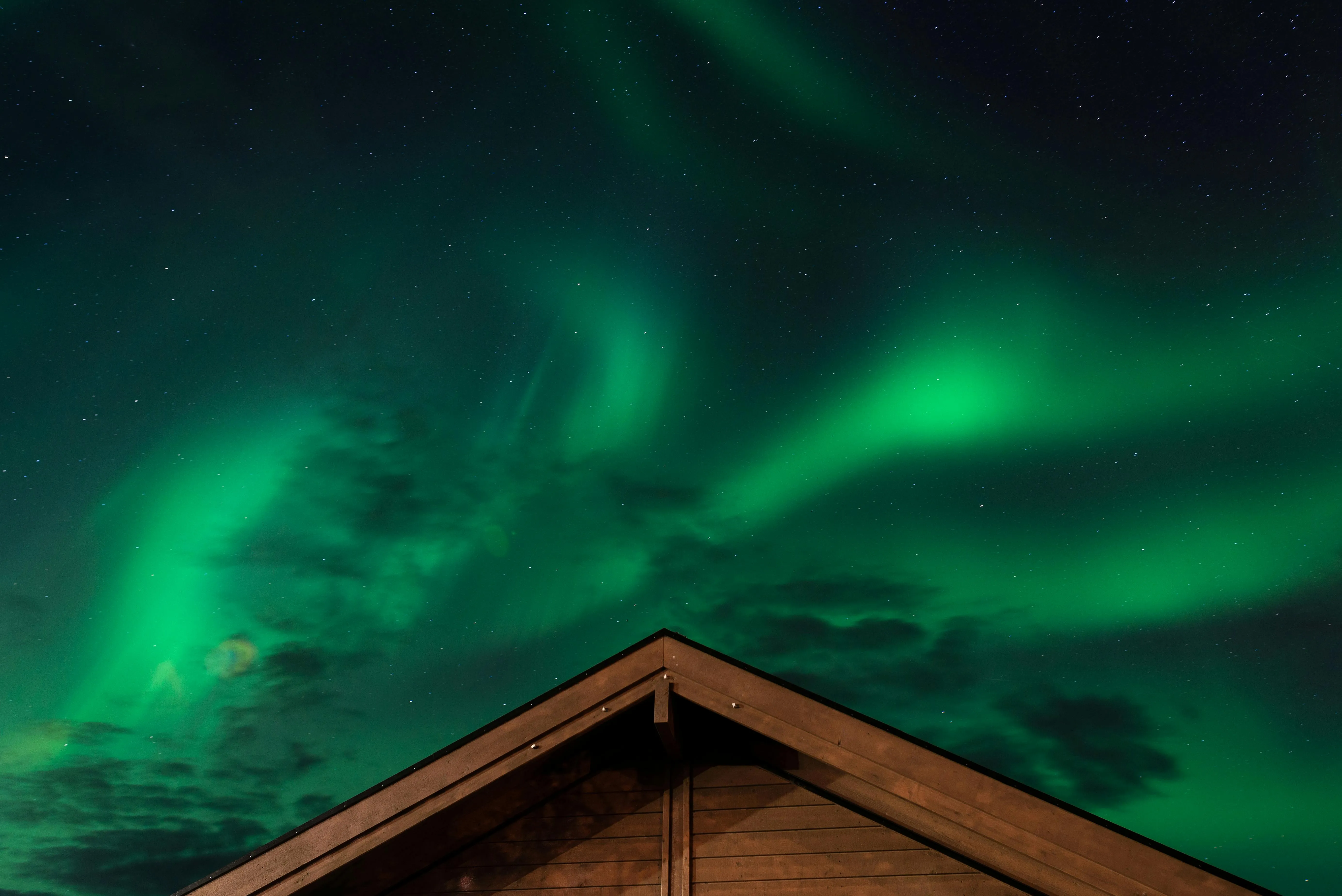 a brown house under the aurora borealis for are neon lights plasma