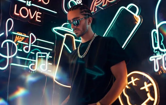 a man standing in front of neon signs for do neon lights burn out