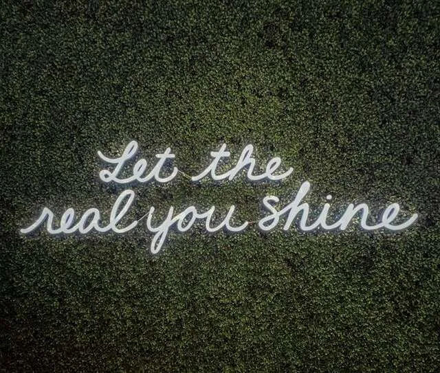 a grass wall with a neon sign for how to hang neon sign on grass wall