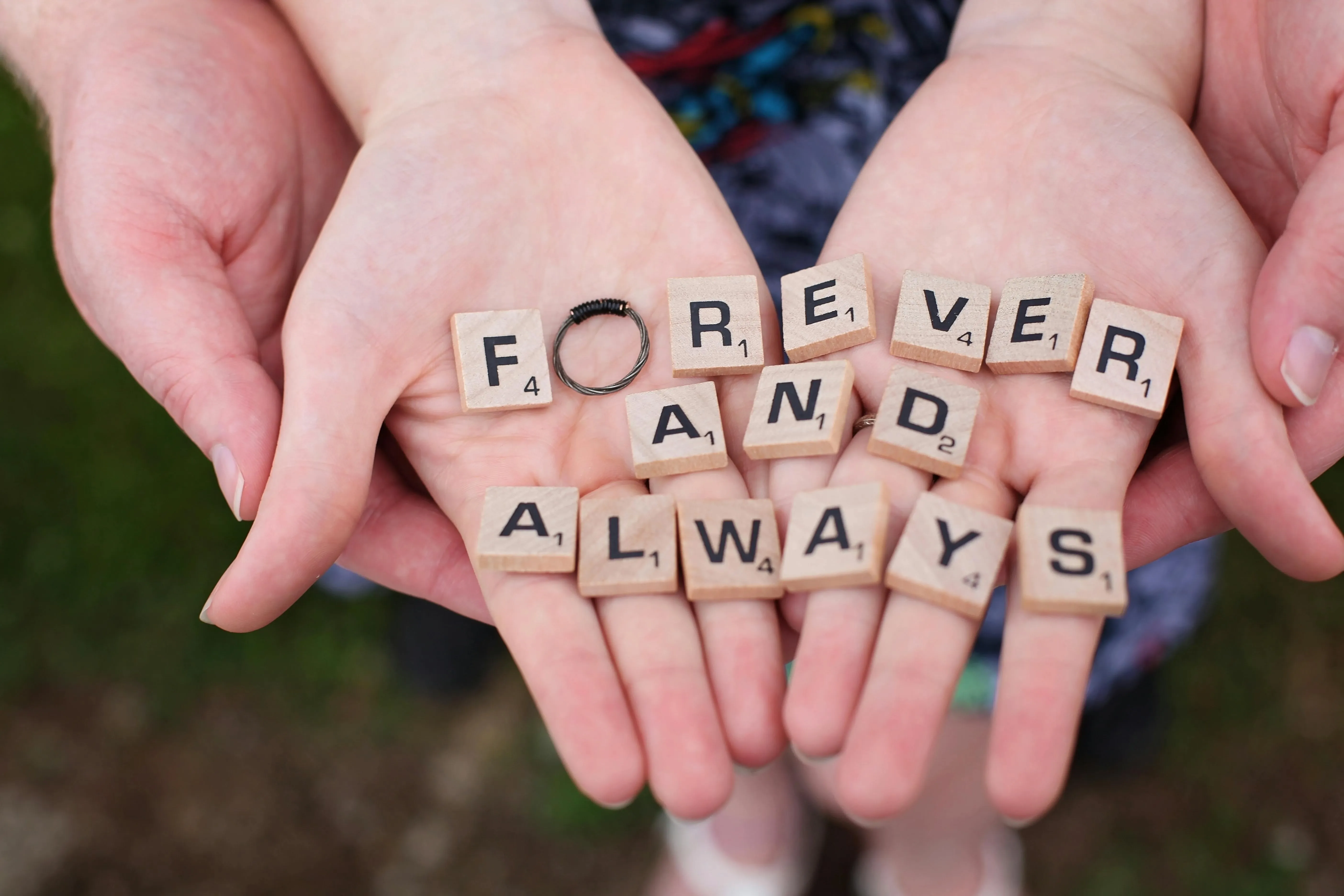 scrabble tiles on a person’s hands for engagement party ideas